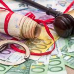 European Enforcement Orders (EEO) | Handcuffs and euro bills and wooden gavel as crime concept